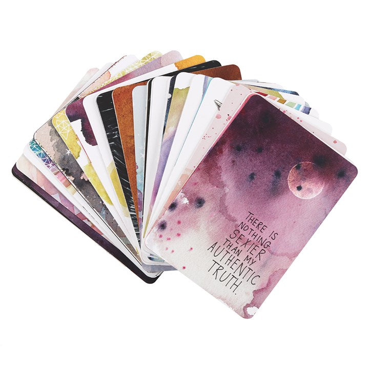 The image shows a selection of oracle cards - one can be read as "There is nothing sexier than my authentic truth" laid out on a white surface 