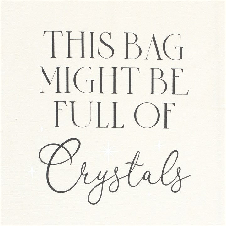 A white cotton tote bag with the text 'This bag might be full of crystals' printed on the front