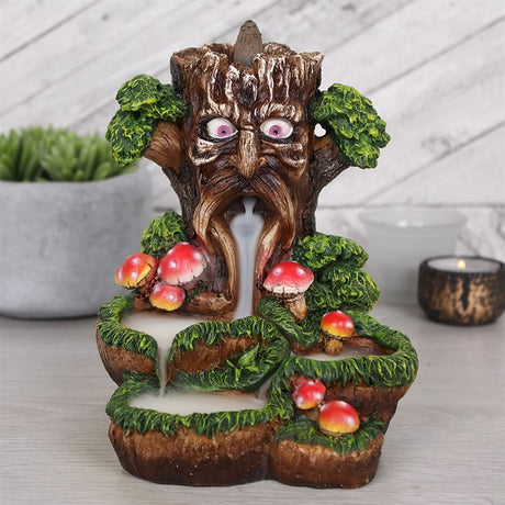 A colourful backflow incense burner featuring the Tree Man design with toadstools around it. The burner is made of resin.