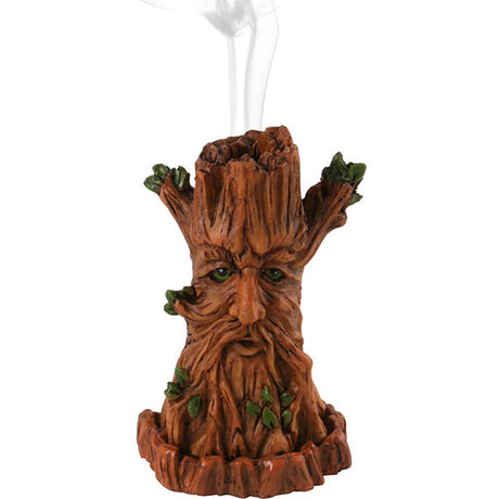 A Tree Man design incense holder with smoke rising from the top, resembling a face made of leaves and a tree trunk.