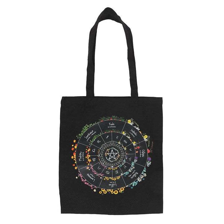 Black tote bag with colourful wheel of the year design on a white background