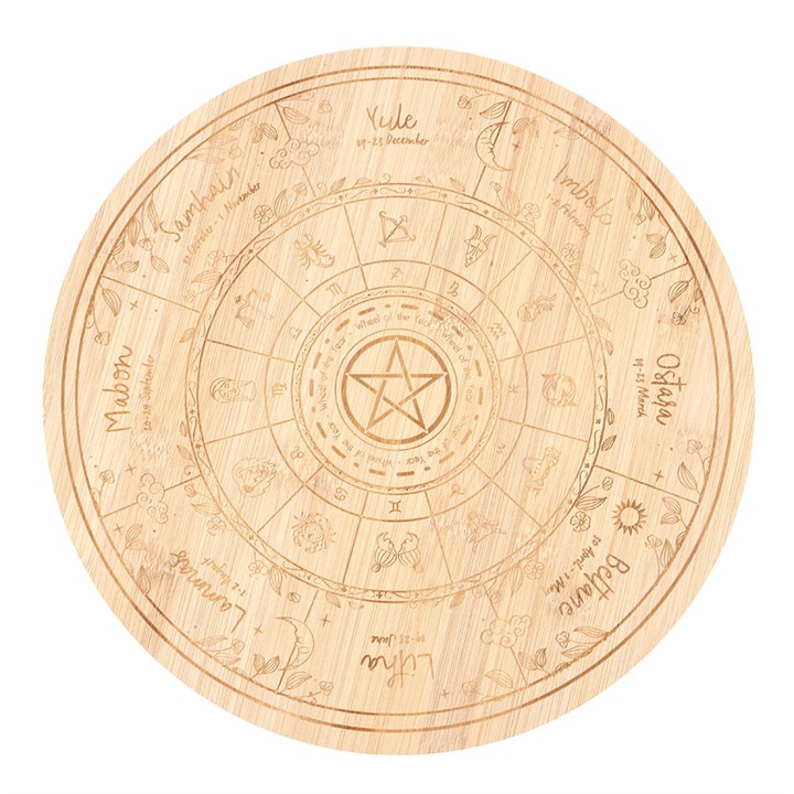 Wooden cutting board with engraved wheel of the year design on a white background
