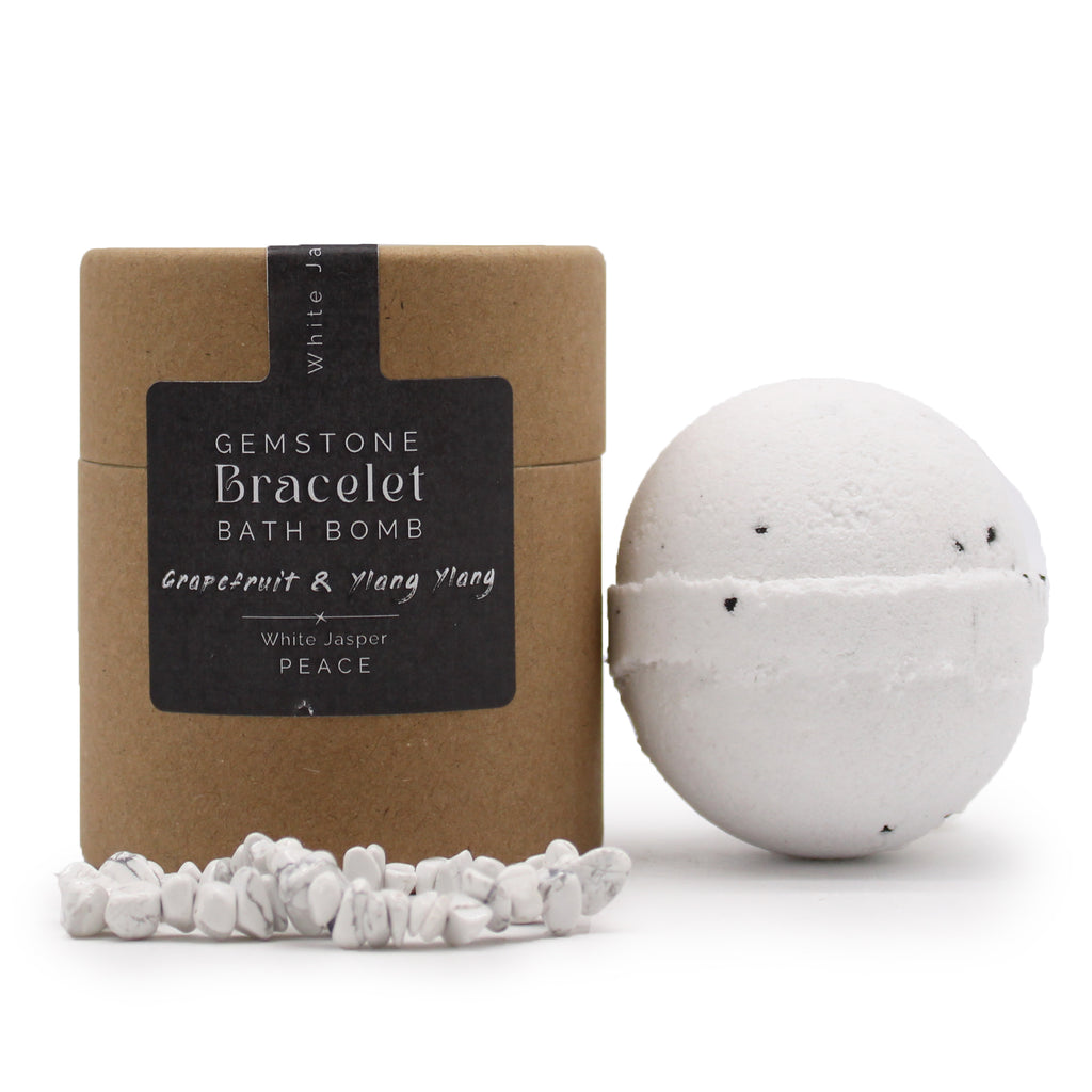A bath bomb with a white jasper gemstone bracelet and grapefruit-scented, packaged in a brown kraft paper box and a white bracelet visible outside the box.