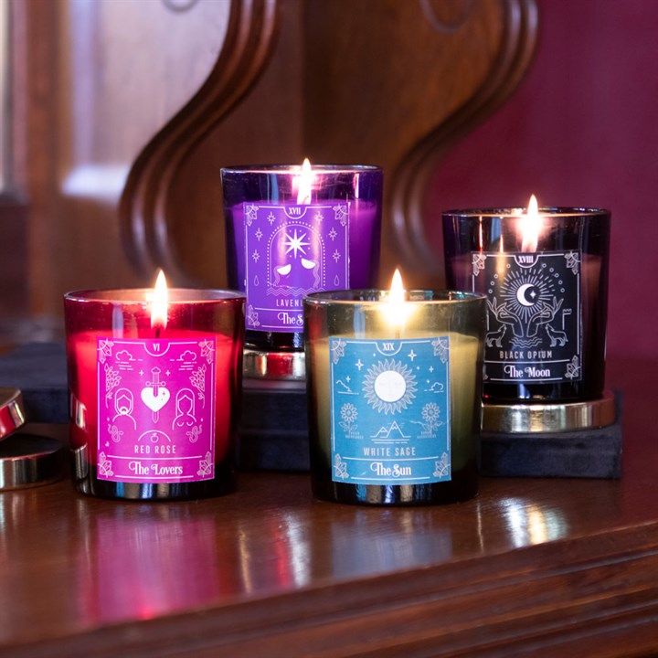 Four tarot themed colourful lit candles
