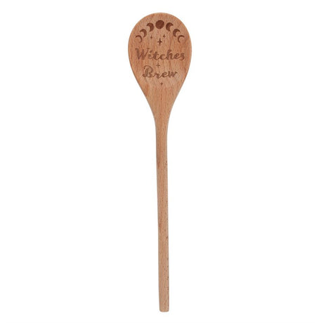 A wooden spoon with 'WITCHES BREW' text and decorative moon and star symbols engraved on it, used as a kitchen decorative or functional item.