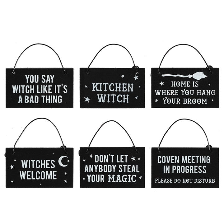 A collection of 6 black mini witchy signs with white font with phrases such as "Kitchen Witch" and "Don't let anybody steal your magic"