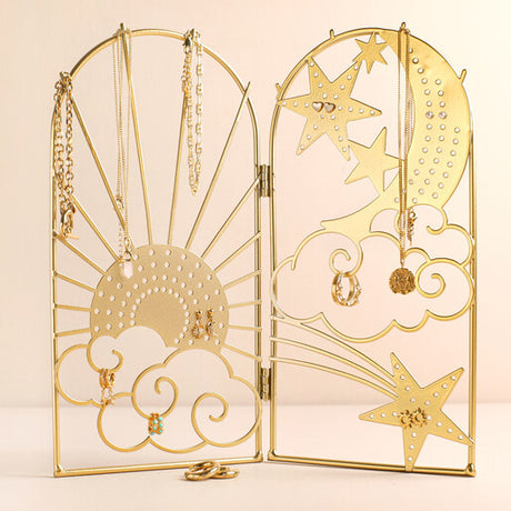A celestial inspired jewellery stand with sun, moon and star designs 