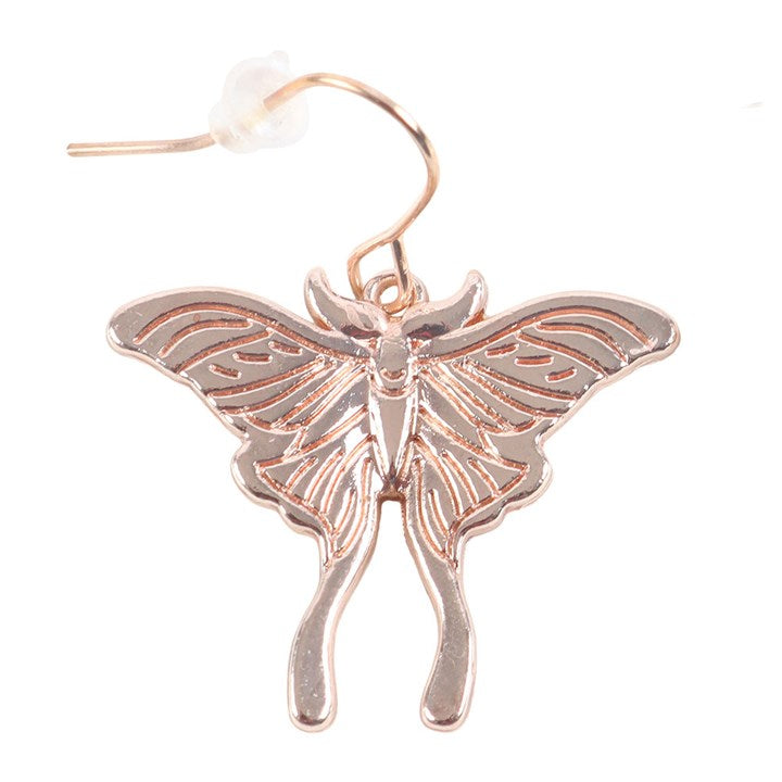 Close up of a dangling lunar moth earring