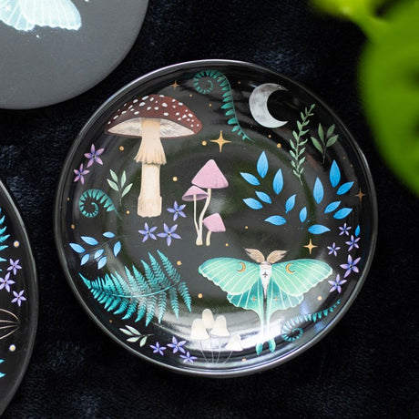 A round trinket bowl with mushroom design on a decorative background
