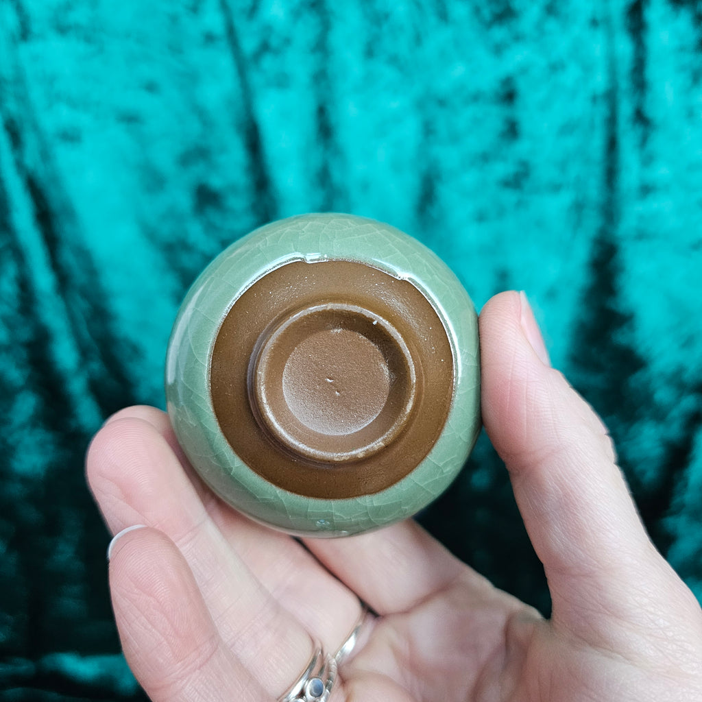 A green ceramic tea bowl from underneath