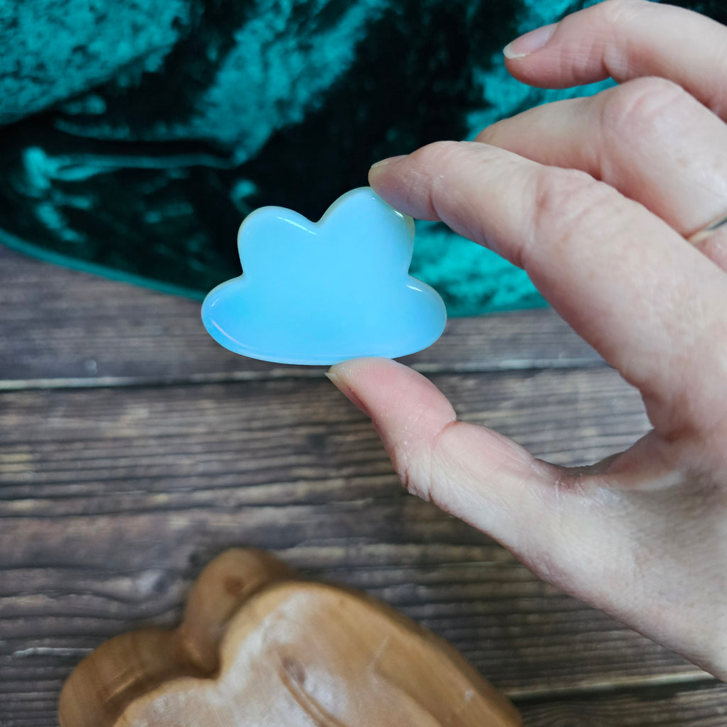 Carved Opalite crystal cloud held in a hand