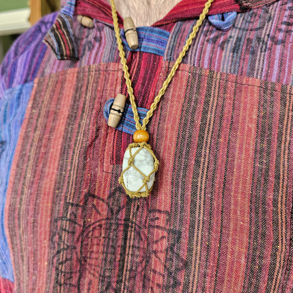 A sand-coloured crystal cord necklace with an example crystal inside