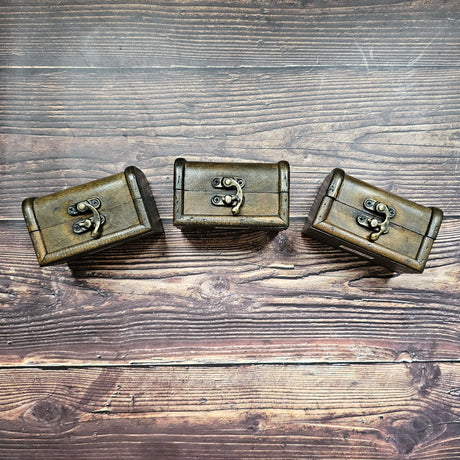 Three small brown "treasure chest" with metal closures. 