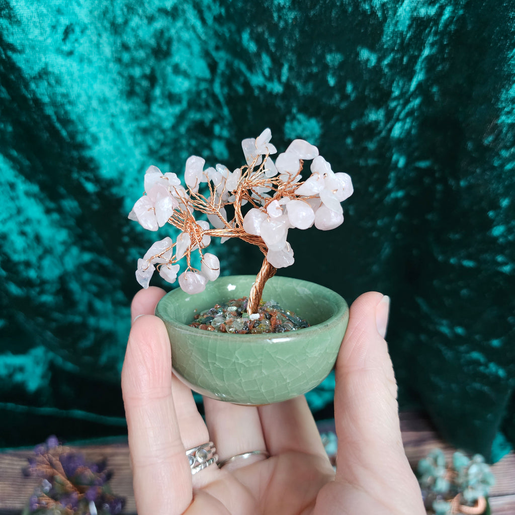 A Rose Quartz crystal tree in a ceramic tea bowl.