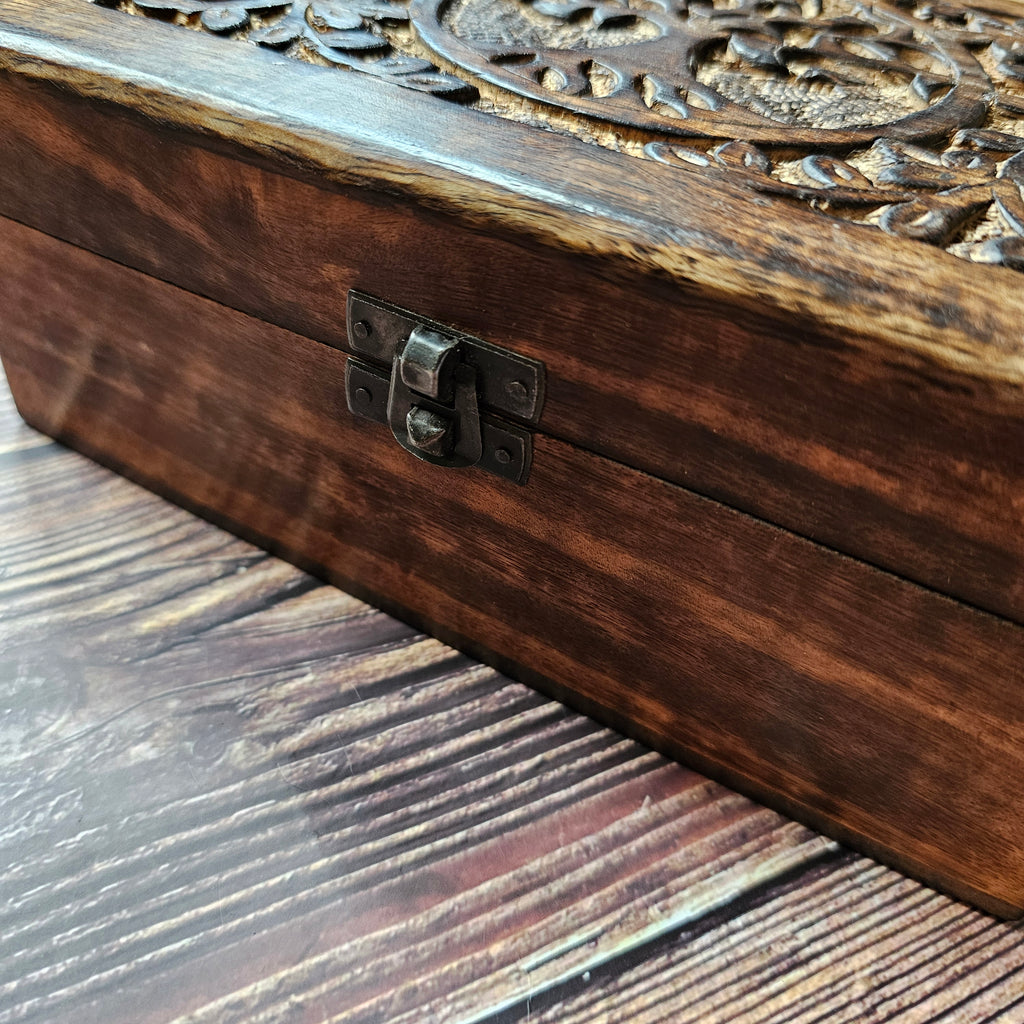 A close up of a metal closure on a wooden box