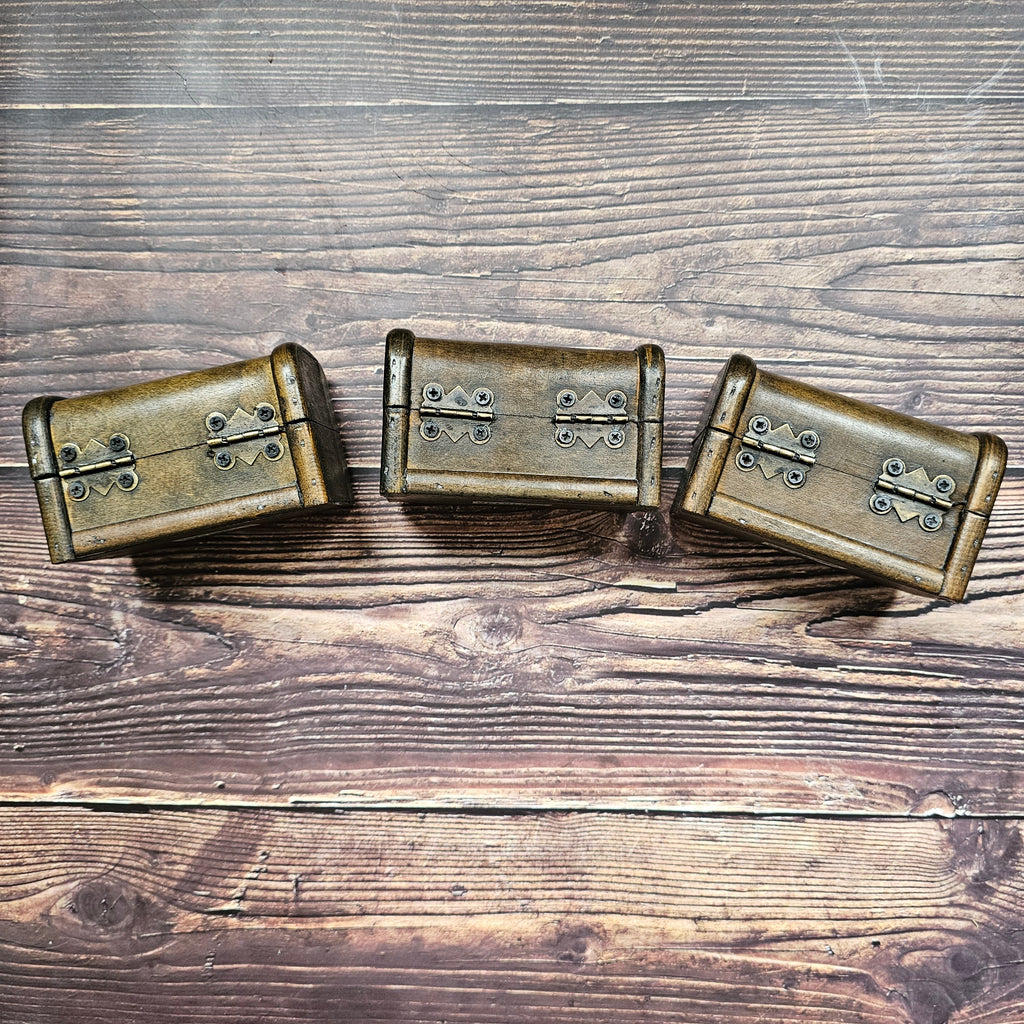 Three small brown "treasure chest" with metal hinges. 